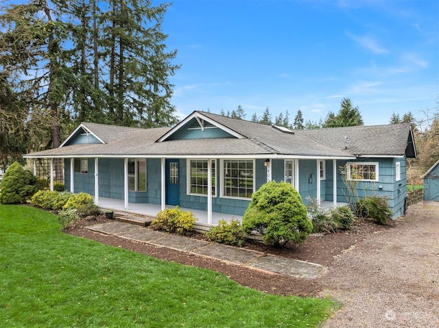 single story home with covered porch and a front lawn