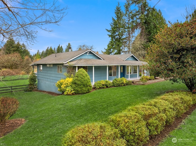 view of front of home with a porch and a front yard