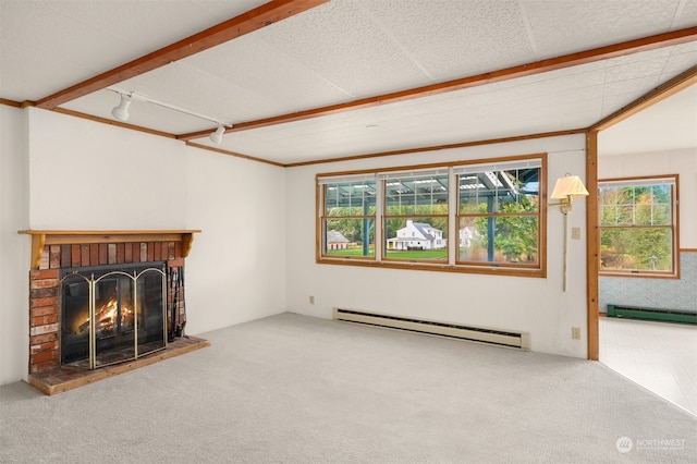 unfurnished living room featuring carpet flooring, a fireplace, crown molding, and baseboard heating