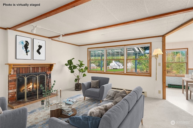 living room featuring a baseboard heating unit, carpet floors, crown molding, and a brick fireplace