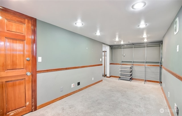 basement featuring light carpet