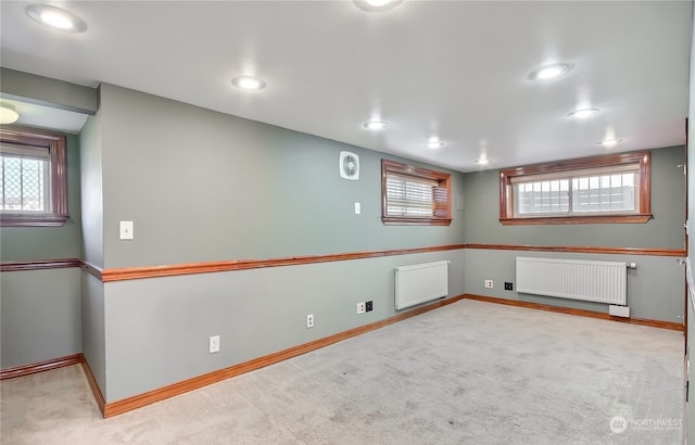 basement with light colored carpet and radiator