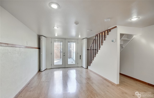 entryway with french doors and light wood-type flooring