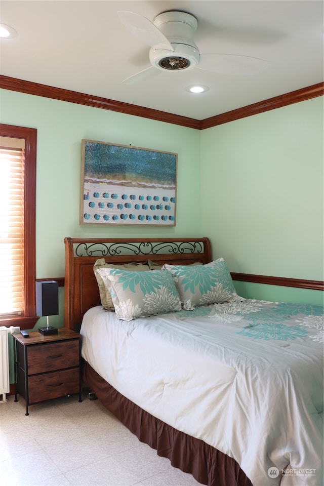 bedroom featuring radiator, ceiling fan, and crown molding