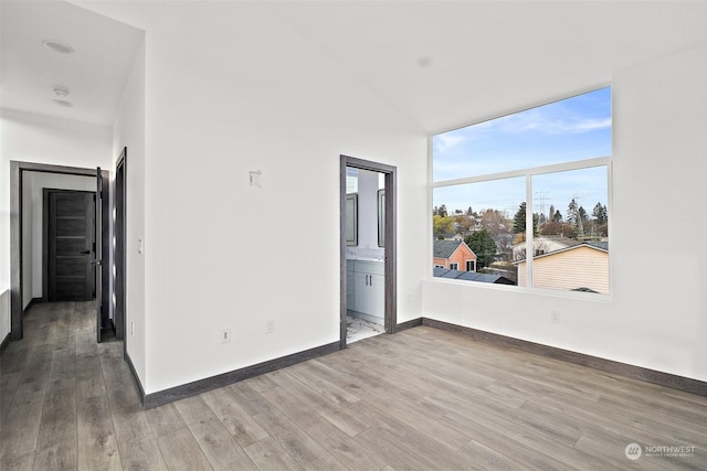 empty room with hardwood / wood-style floors