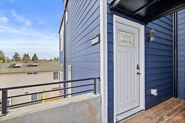 view of exterior entry featuring a balcony