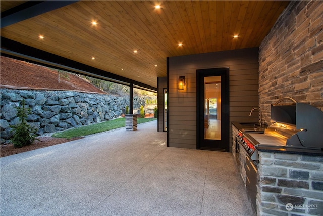 view of patio with area for grilling and sink