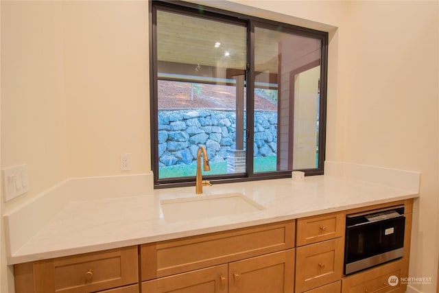 kitchen with sink and light stone countertops