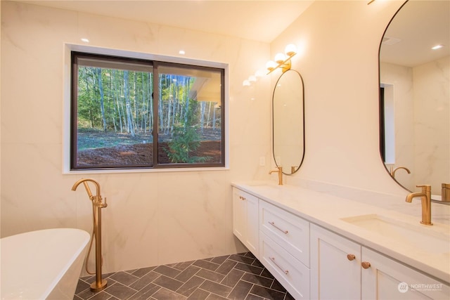 bathroom featuring vanity and a tub to relax in