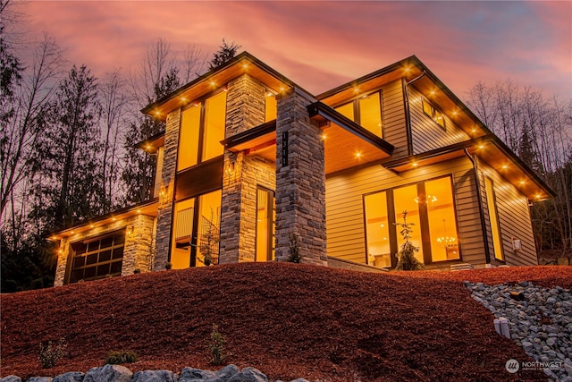 property exterior at dusk featuring a garage