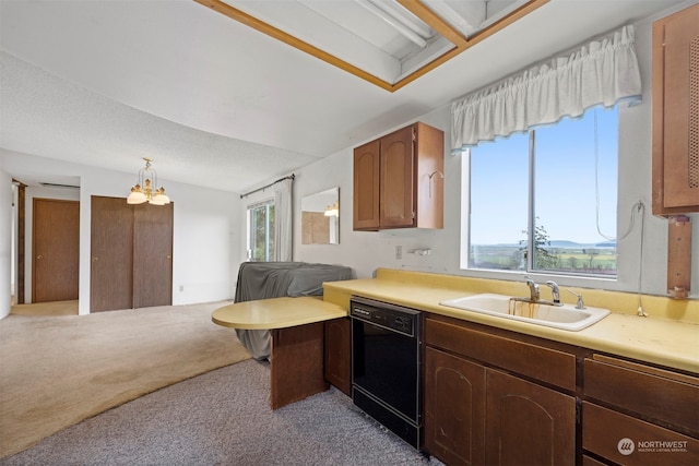 kitchen featuring dishwasher, sink, an inviting chandelier, pendant lighting, and light carpet