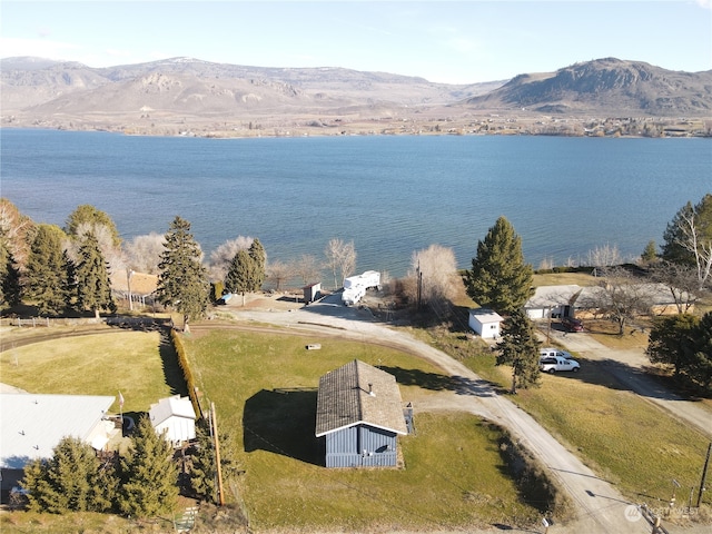 drone / aerial view with a water and mountain view