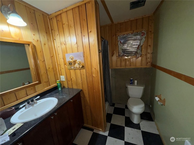 76B Westlake Rd, Oroville, WA 98844 - full bath with tile patterned floors, vanity, toilet, a shower with shower curtain, and wood walls