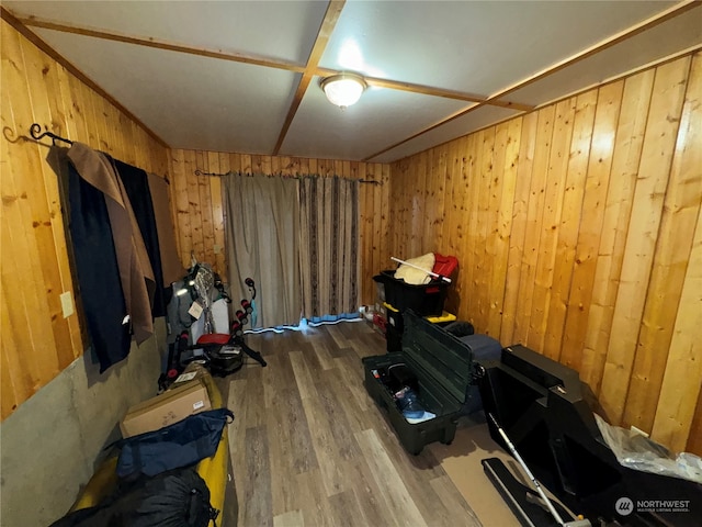 misc room featuring hardwood / wood-style floors and wood walls