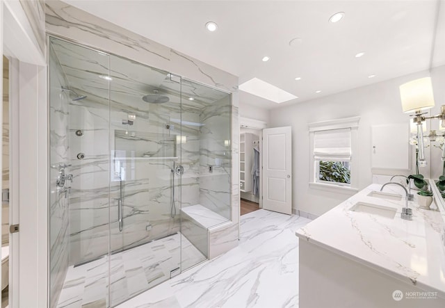 bathroom with vanity, a skylight, and walk in shower