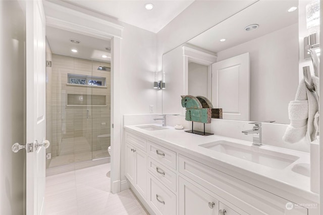 bathroom featuring tile patterned flooring, vanity, toilet, and walk in shower