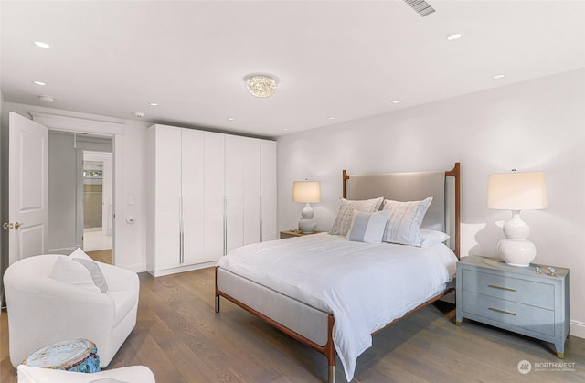 bedroom featuring dark hardwood / wood-style flooring