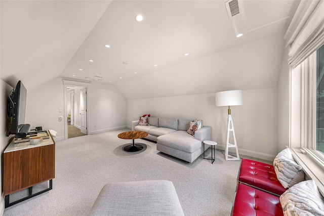 carpeted living room featuring vaulted ceiling