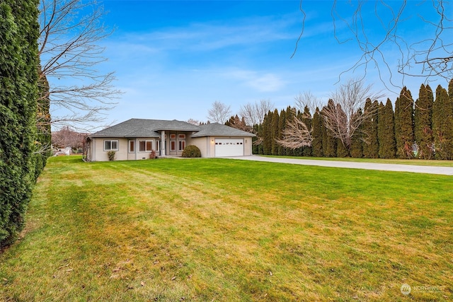 view of front of house with a garage and a front yard