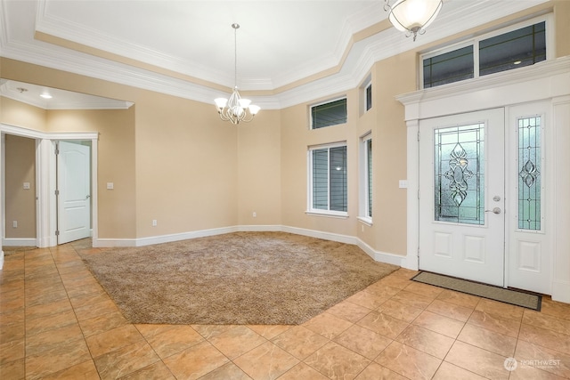 foyer featuring a raised ceiling, light tile patterned floors, crown molding, and an inviting chandelier