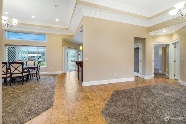 interior space with a notable chandelier, a raised ceiling, ornamental molding, and light tile patterned floors