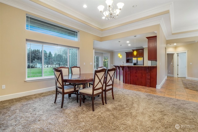 dining space with a chandelier, sink, light colored carpet, and ornamental molding