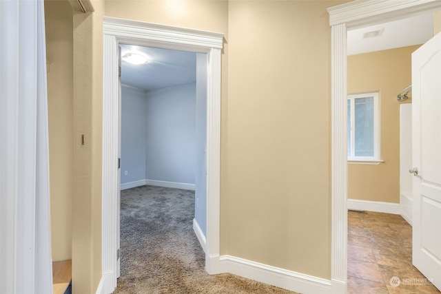 hallway featuring light colored carpet