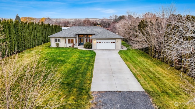 view of front of house with a garage and a front lawn