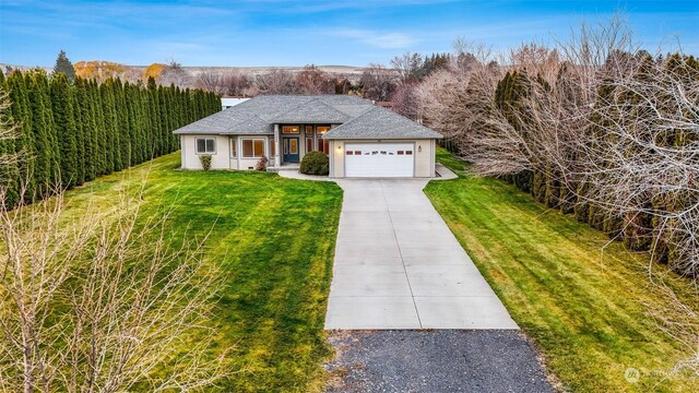 20086 Cherry Rd NW, Soap Lake, WA 98851 - view of front facade with a front yard, concrete driveway, a chimney, and a shingled roof