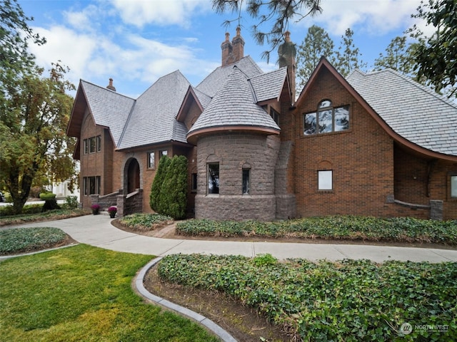 tudor home with a front yard