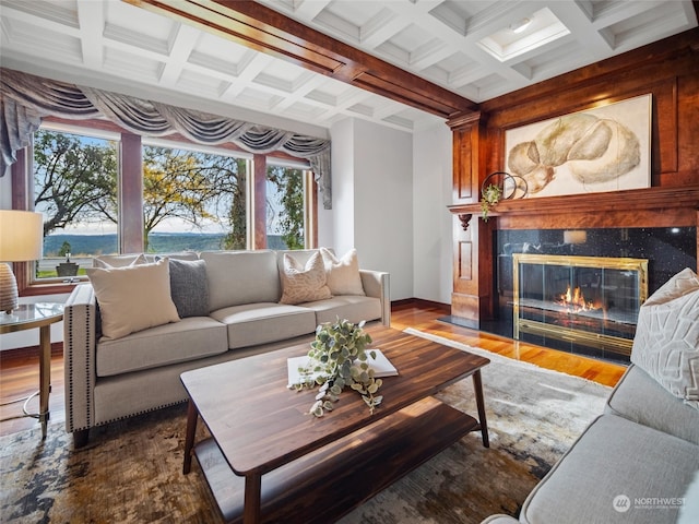 living room with beamed ceiling, hardwood / wood-style flooring, plenty of natural light, and a fireplace