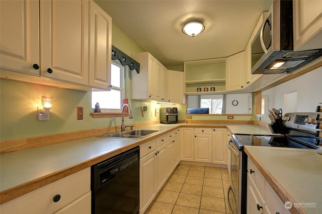 kitchen featuring sink, white cabinets, stainless steel appliances, and light tile patterned floors