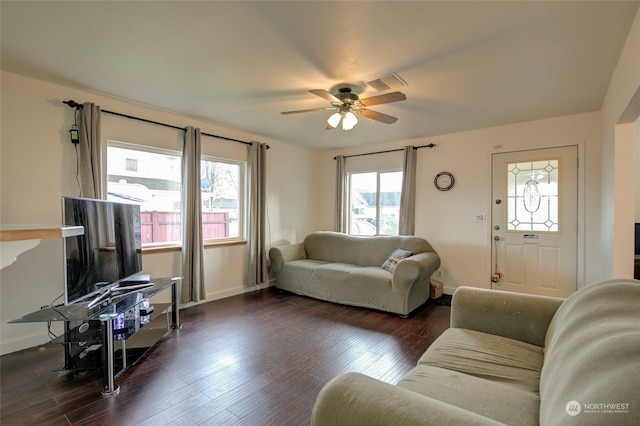 living room with ceiling fan and dark hardwood / wood-style flooring