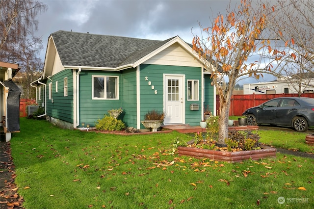 bungalow-style home with a front lawn