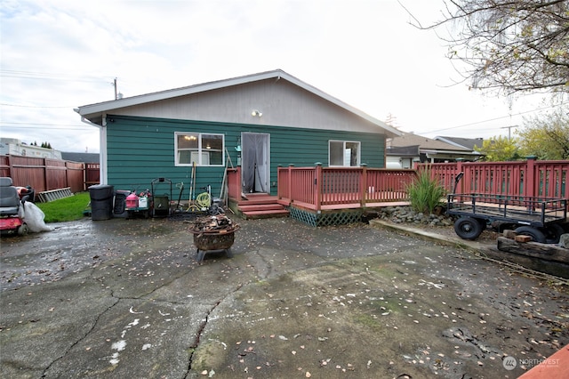 rear view of house with a patio and a wooden deck