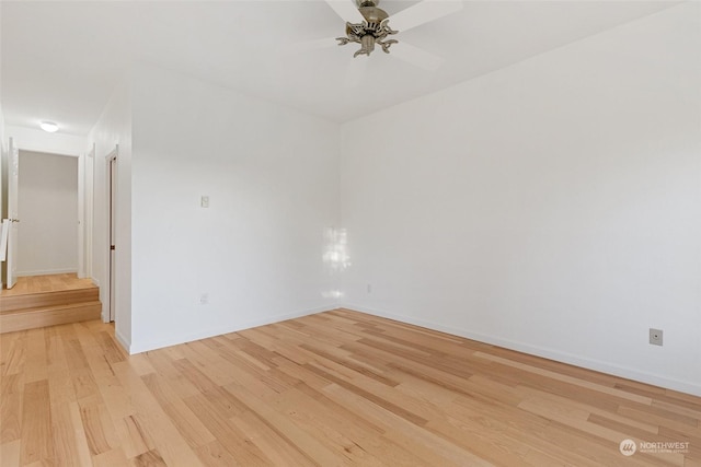 spare room with ceiling fan and light hardwood / wood-style floors