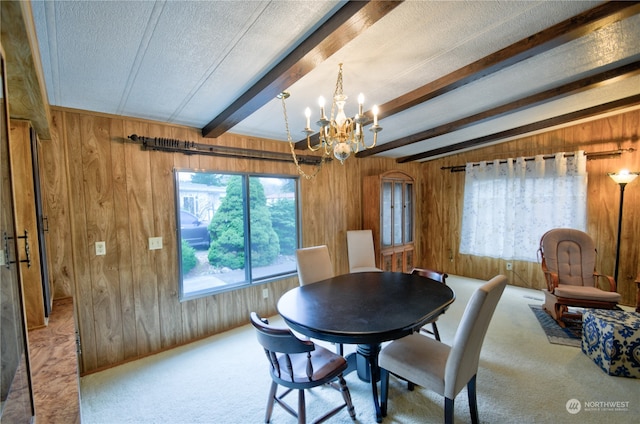 dining area with wood walls and beamed ceiling