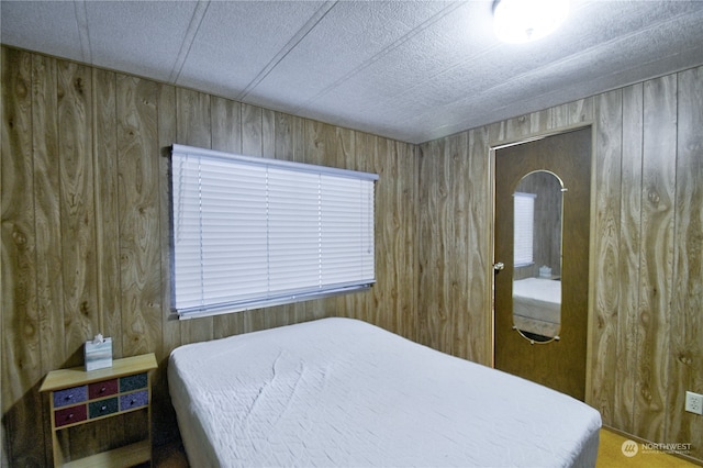 bedroom with wooden walls