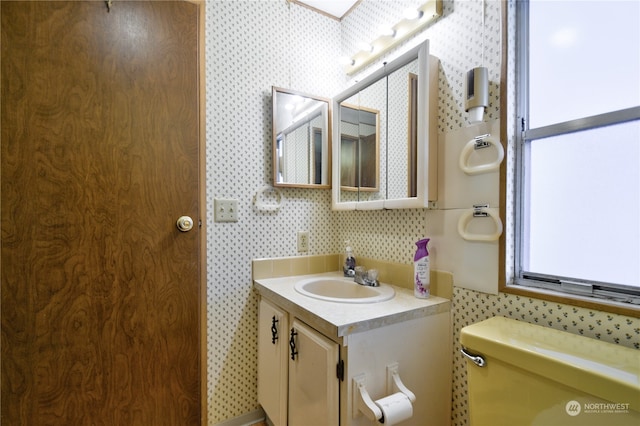 bathroom featuring vanity and toilet