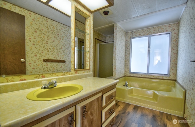 bathroom with vanity, plus walk in shower, and hardwood / wood-style flooring