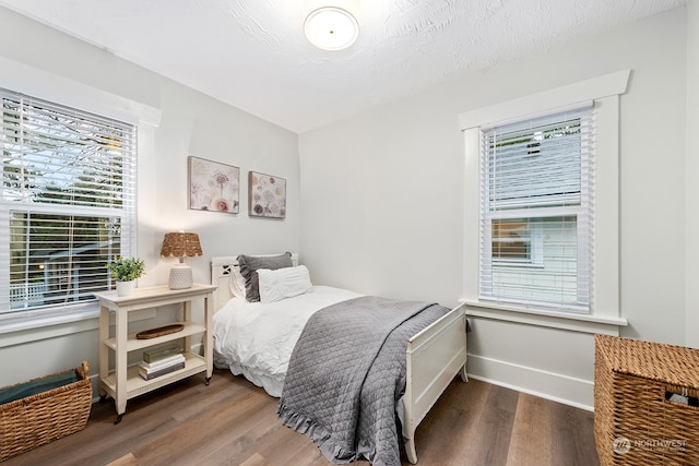 bedroom featuring a textured ceiling and hardwood / wood-style flooring