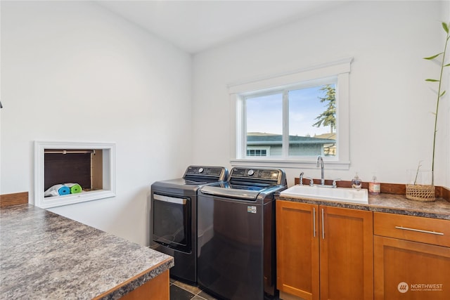 clothes washing area featuring separate washer and dryer, sink, cabinets, and tile patterned flooring