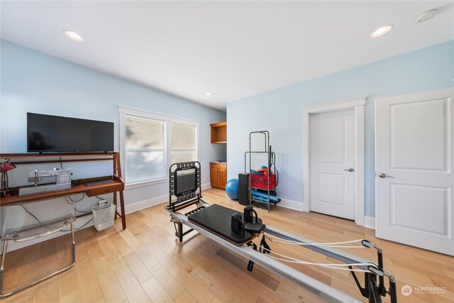 workout room with light hardwood / wood-style floors