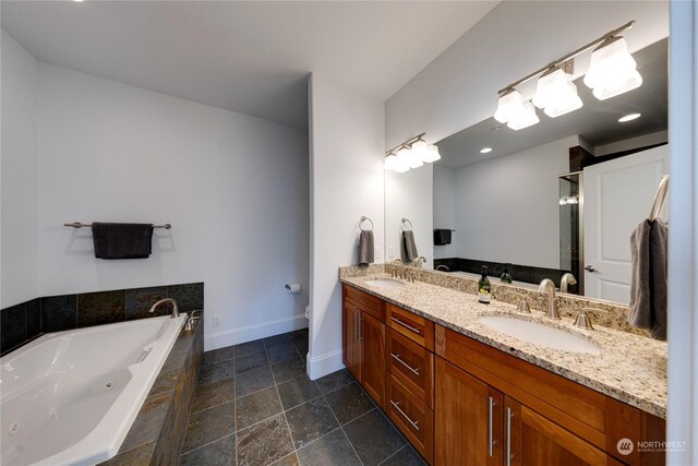 bathroom featuring tiled bath and vanity