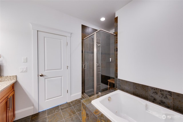 bathroom with tile patterned flooring, vanity, and shower with separate bathtub