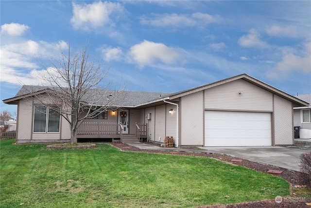 ranch-style house featuring a garage and a front lawn