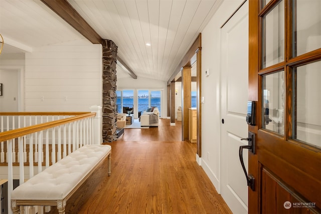 hall with wooden ceiling, lofted ceiling with beams, decorative columns, wood-type flooring, and a water view