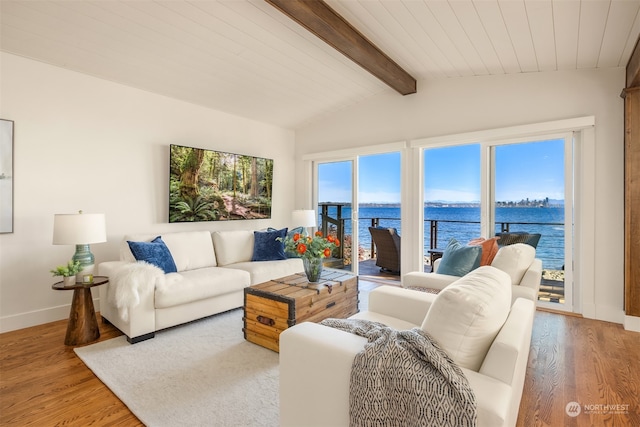 living room with hardwood / wood-style floors, vaulted ceiling with beams, a water view, and wooden ceiling