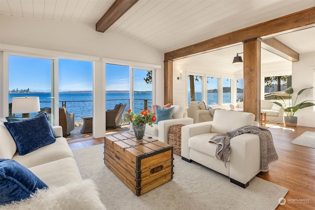 sunroom with a water view and lofted ceiling with beams