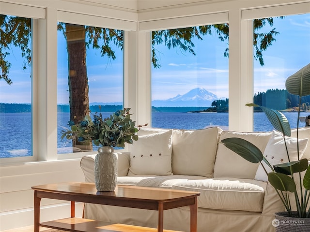 sunroom / solarium with plenty of natural light and a water and mountain view